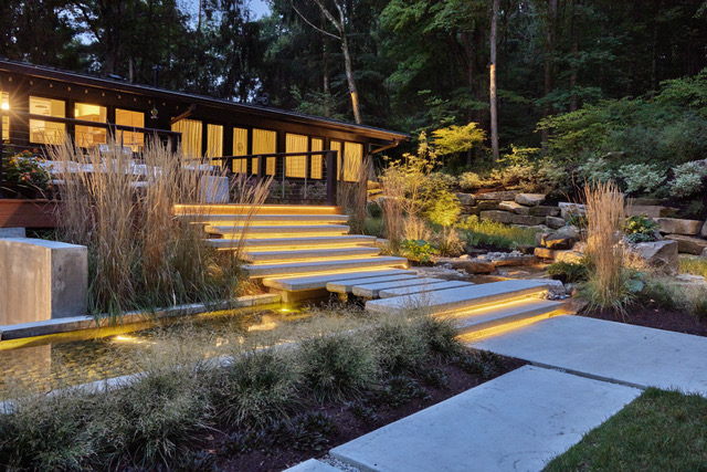 beautiful patio with lit steps and great landscaping